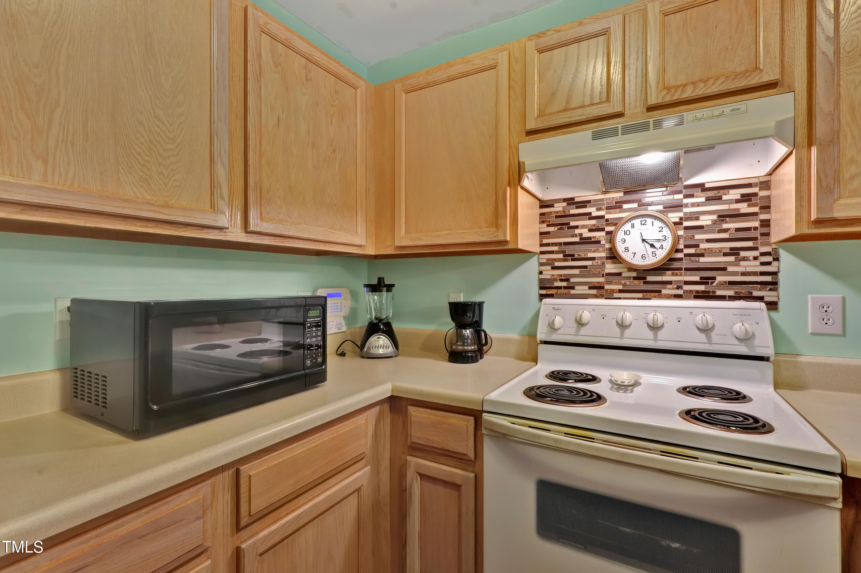 603 East Martin Street Raleigh, NC 27601 - Photo 10 of 25 a kitchen with a stove and cabinets