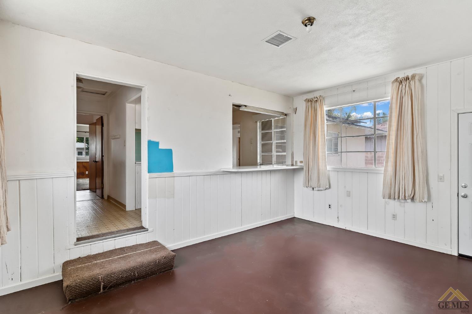 Undisclosed Address Wasco, CA 93280 - Photo 11 of 30 wooden floor in an empty room with a window
