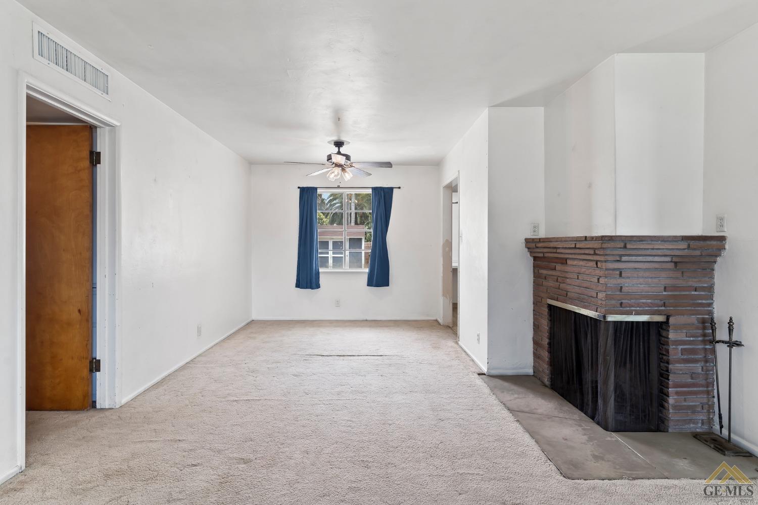 Undisclosed Address Wasco, CA 93280 - Photo 13 of 30 an empty room with fireplace