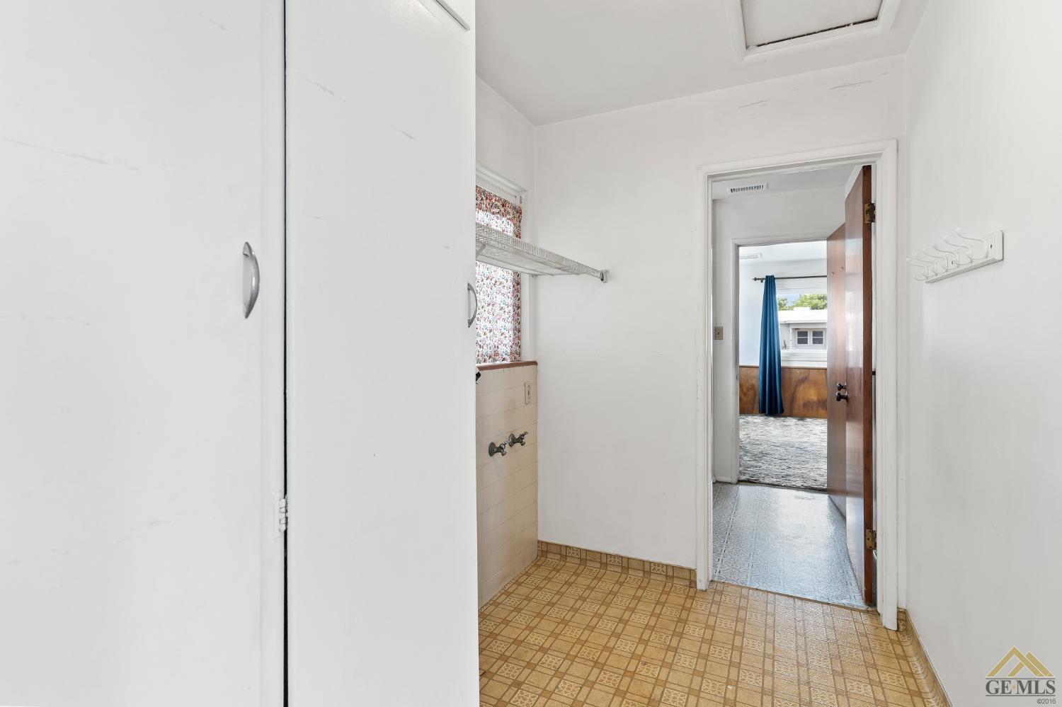 Undisclosed Address Wasco, CA 93280 - Photo 16 of 30 a view of a hallway with wooden floor and a bathroom
