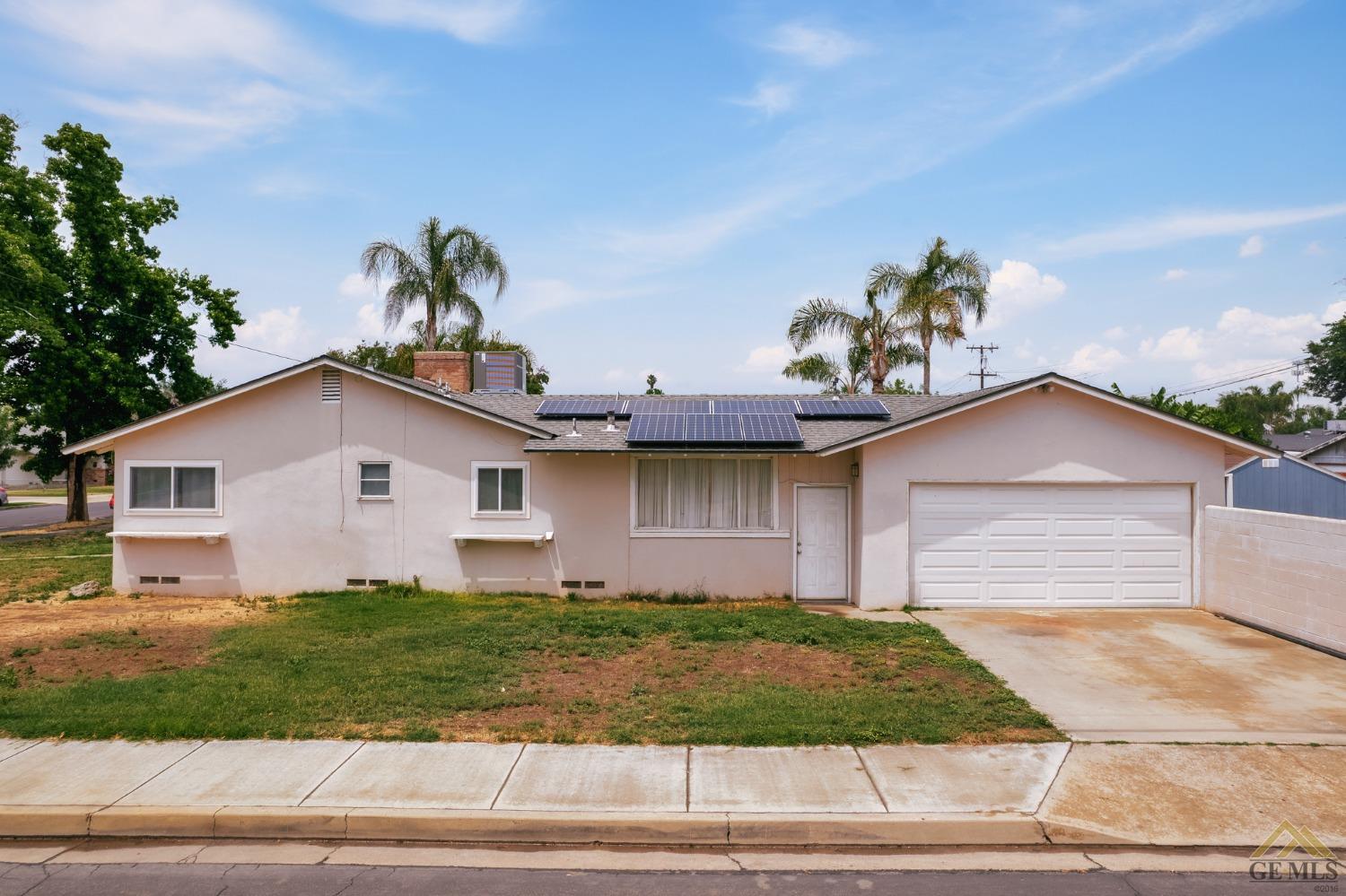 Undisclosed Address Wasco, CA 93280 - Photo 2 of 30 a front view of a house with a yard and garage