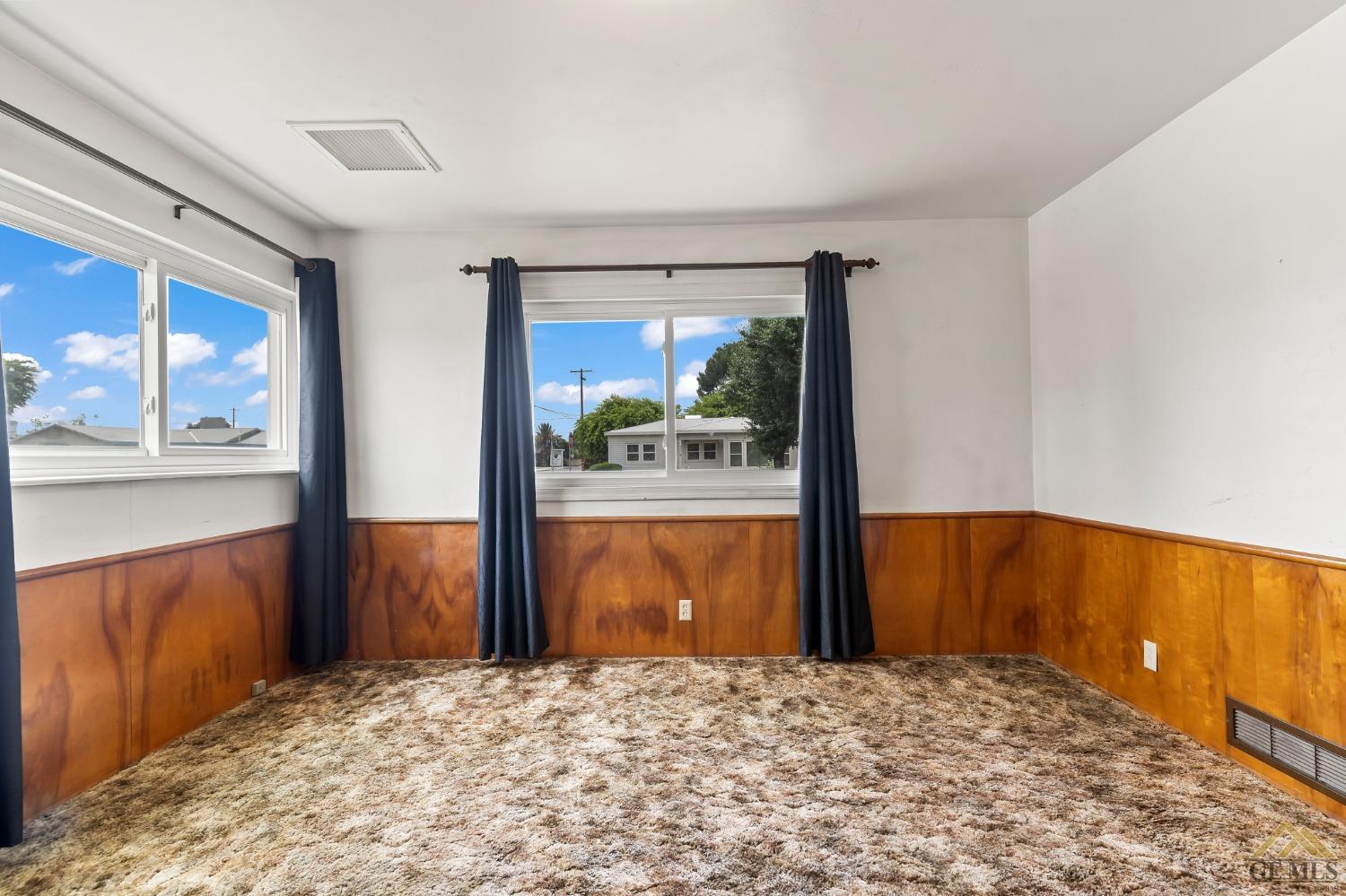 Undisclosed Address Wasco, CA 93280 - Photo 21 of 30 a view of a bedroom with a large bed and wooden floor