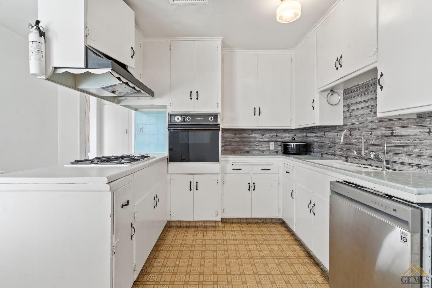 Undisclosed Address Wasco, CA 93280 - Photo 4 of 30 a kitchen with granite countertop a sink a stove and cabinets