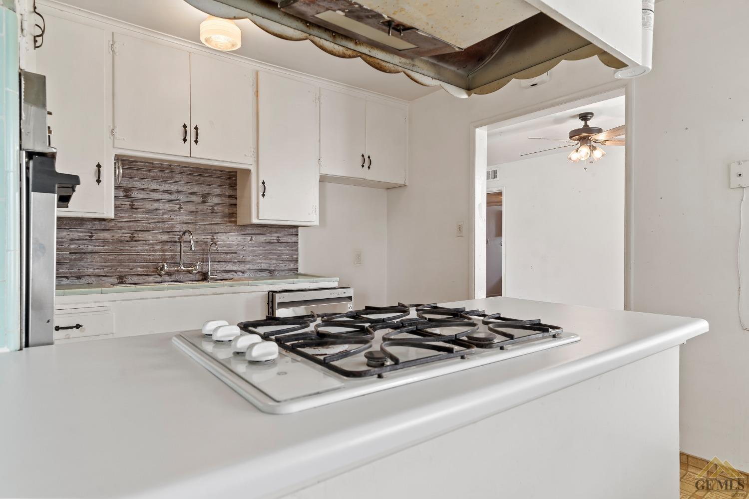 Undisclosed Address Wasco, CA 93280 - Photo 6 of 30 a white stove top oven sitting inside of a kitchen