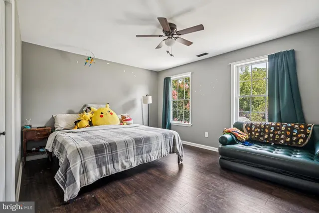 a bedroom with a bed couch and window