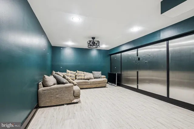 a spacious bedroom with a bed and glass walk in closet