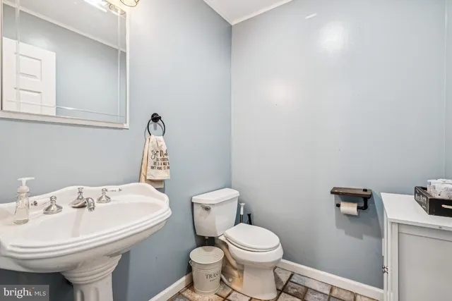 a bathroom with a sink a toilet and mirror