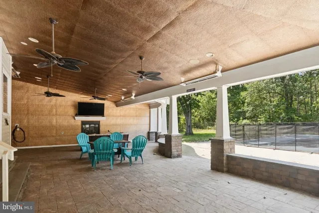 a view of a patio with table and chairs