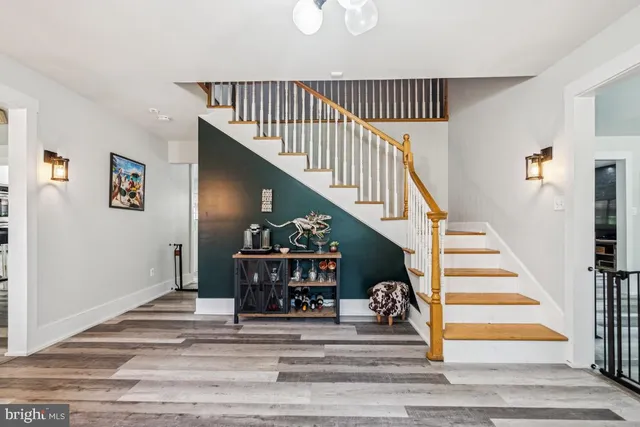 a view of entryway bedroom and hall with wooden floor