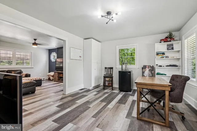 a workspace with furniture window and wooden floor