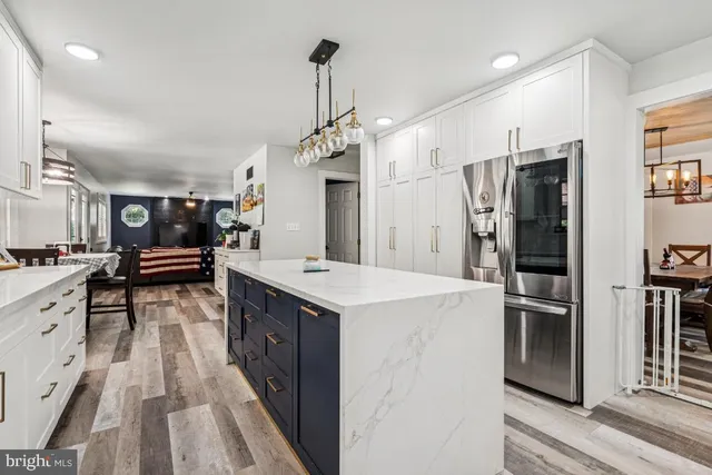 a kitchen with stainless steel appliances a sink stove and refrigerator