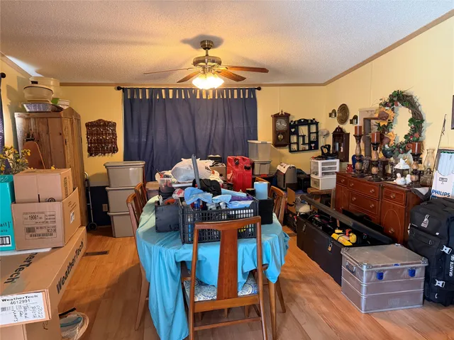 a living room with furniture and a dining table