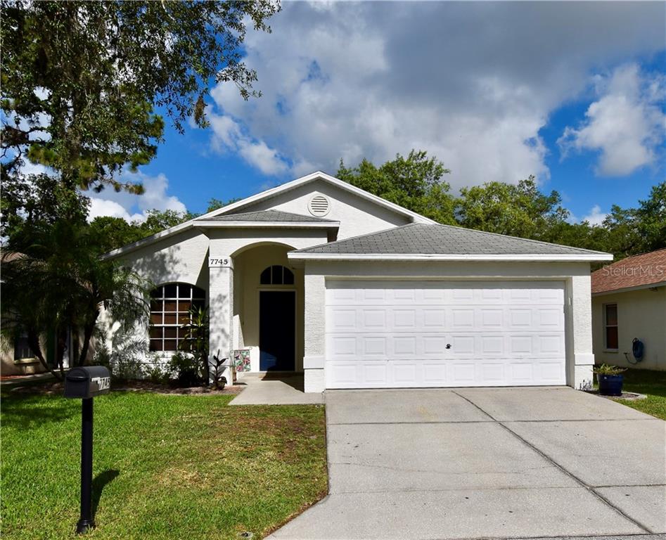 7745 Barclay Road New Port Richey, FL 34654 - Photo 1 of 1 a front view of house with yard