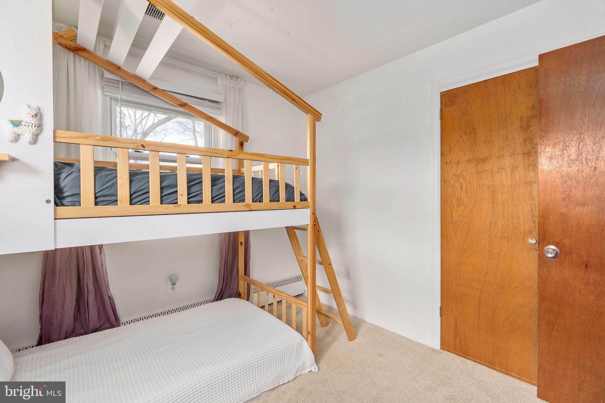 6714 Ruskin Street Springfield, VA 22150 - Photo 27 of 63 a bedroom with a bed and wooden floor