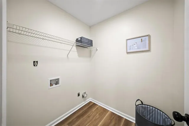 a view of a room with wooden floor