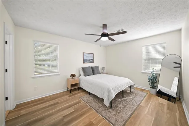 a spacious bedroom with a bed and a large window