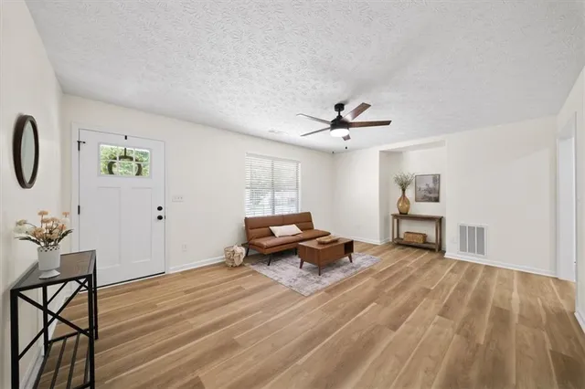 a living room with furniture and wooden floor