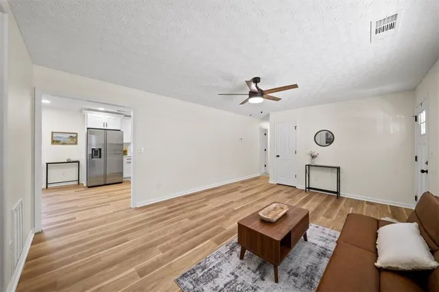 a living room with furniture and a wooden floor