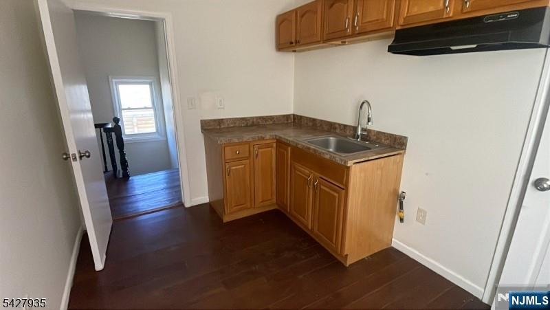 120 South 7th Street, Unit 3 Newark, NJ 07107 - Photo 3 of 5 a kitchen with stainless steel appliances granite countertop a stove a refrigerator and a wooden floor