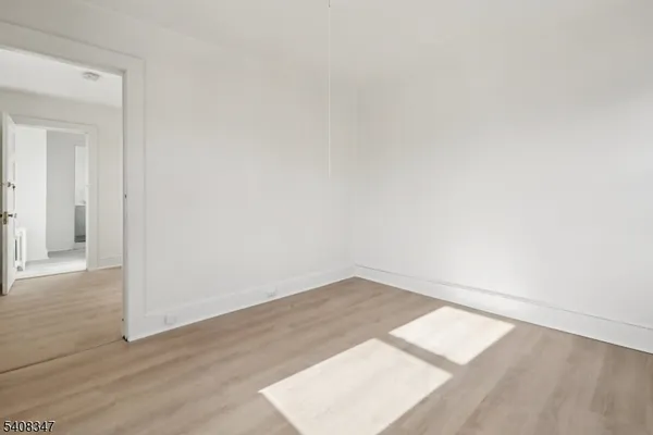 an empty room with wooden floor