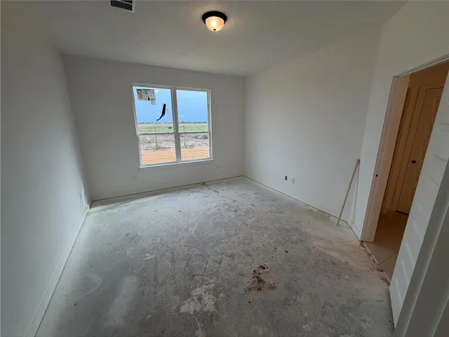 a large white kitchen with a large window