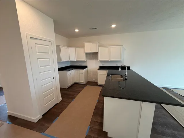 a kitchen with stainless steel appliances a sink stove and cabinets