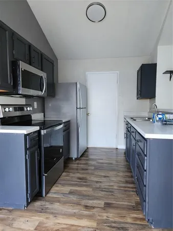 a kitchen with stainless steel appliances and wooden cabinets