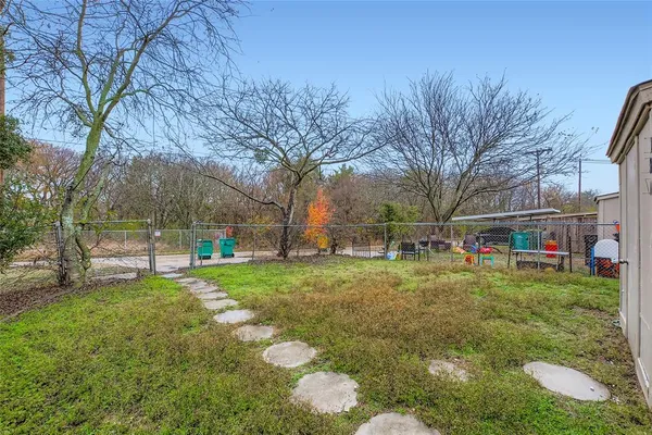 a backyard of a house with table and chairs