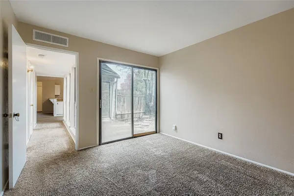 a view of an empty room with glass door