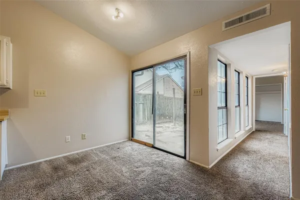 an empty room with sliding glass door