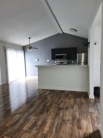 a view of a kitchen with a sink and a refrigerator