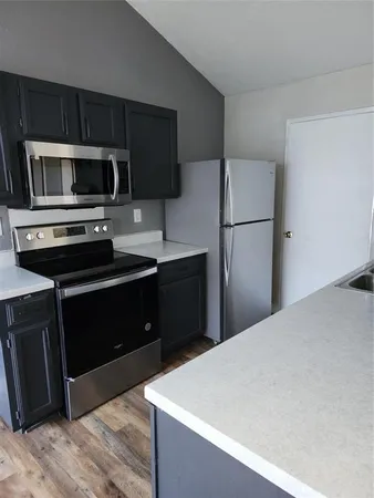 a kitchen with a refrigerator sink and microwave