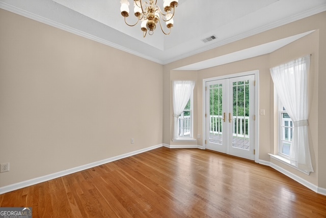 611 Moncrief Road Roberta, GA 31078 - Photo 11 of 30 a view of an empty room with a window and wooden floor