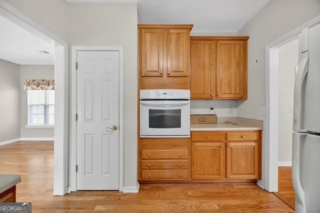 a kitchen with stainless steel appliances granite countertop a refrigerator and a stove