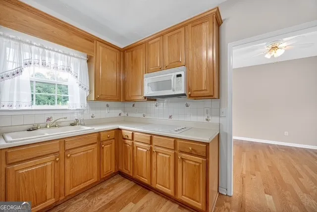 a kitchen with a sink cabinets and wooden floor