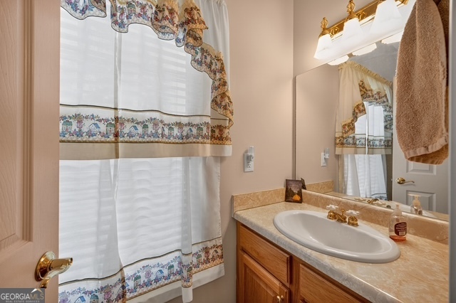 611 Moncrief Road Roberta, GA 31078 - Photo 17 of 30 a bathroom with a sink and mirror