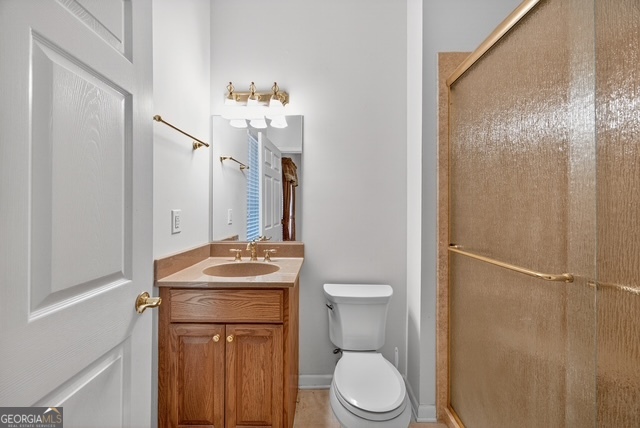 611 Moncrief Road Roberta, GA 31078 - Photo 20 of 30 a bathroom with a sink a toilet and shower