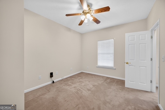 611 Moncrief Road Roberta, GA 31078 - Photo 21 of 30 an empty room with windows and fan