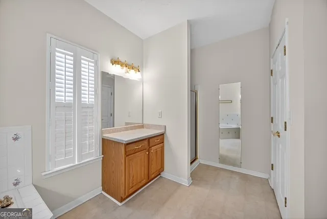 a view of a bathroom with a sink and a mirror