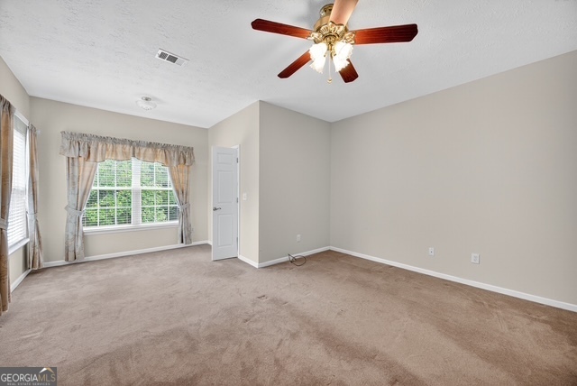 611 Moncrief Road Roberta, GA 31078 - Photo 23 of 30 an empty room with windows and fan