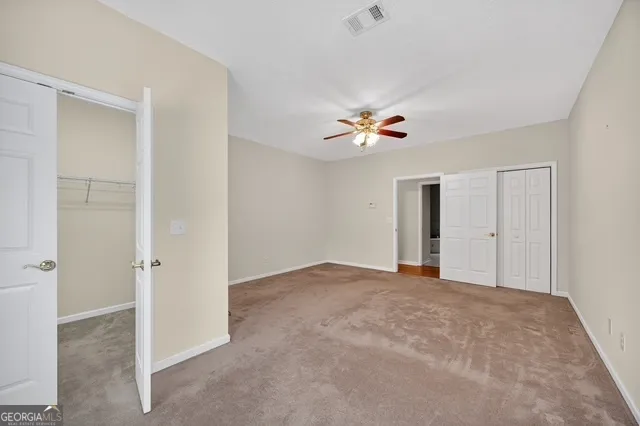 a view of an empty room with a bathroom