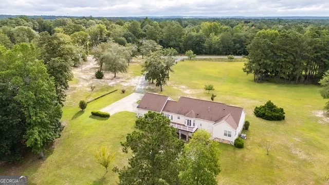 a view of a swimming pool with a yard