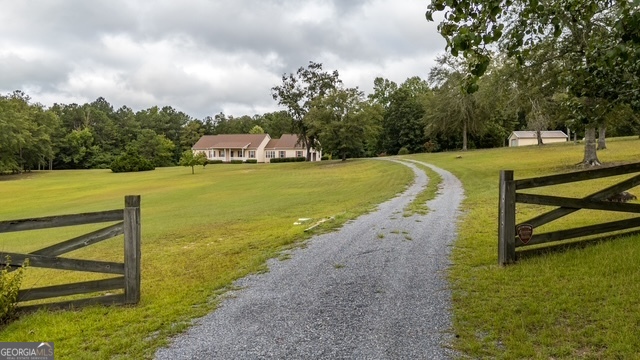 611 Moncrief Road Roberta, GA 31078 - Photo 6 of 30 a view of a swimming pool with a yard and sitting area