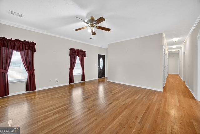 611 Moncrief Road Roberta, GA 31078 - Photo 9 of 30 a view of empty room with wooden floor and fan