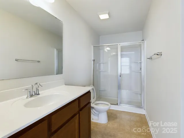 a bathroom with a sink shower and a toilet