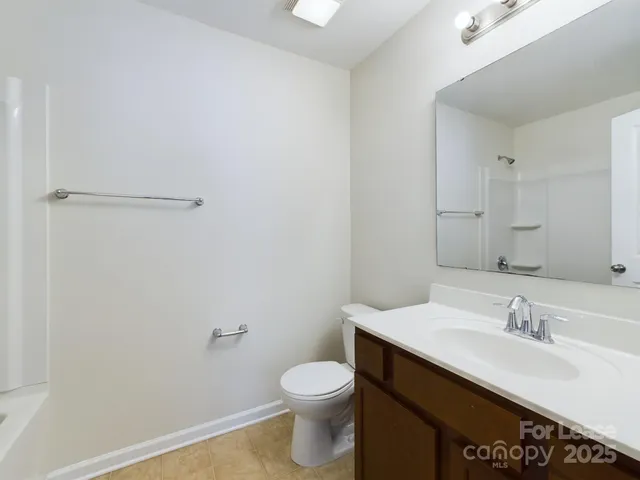 a bathroom with a sink toilet and vanity