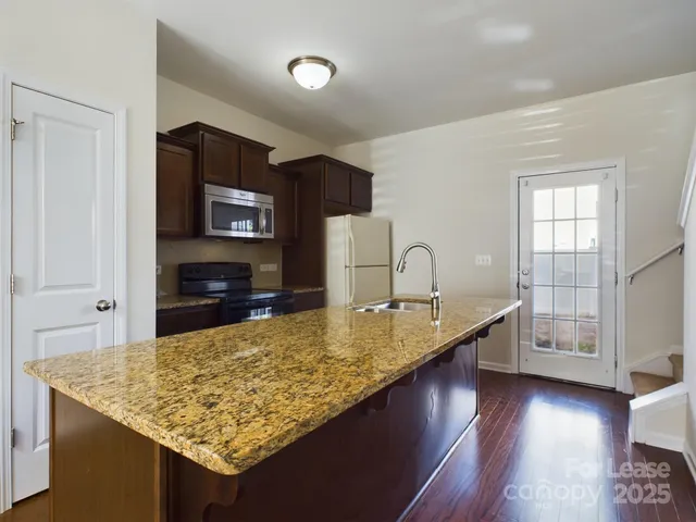 a kitchen with counter top space cabinets and wooden floor