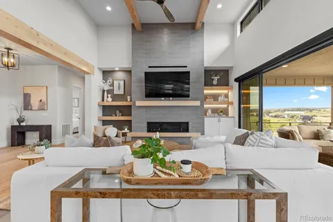 a dining room with furniture and a floor to ceiling window