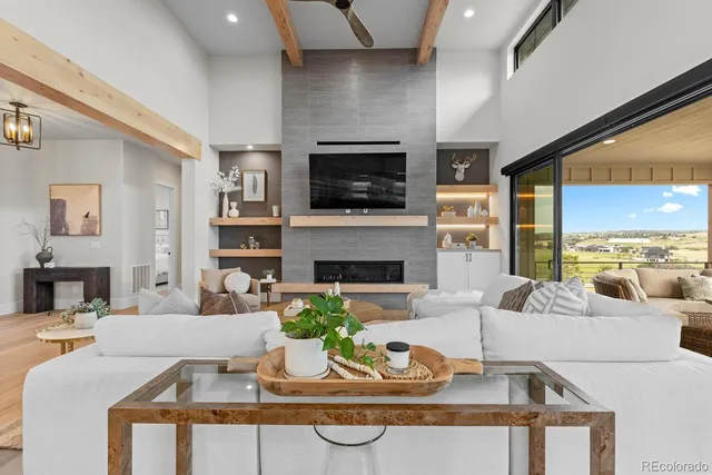 a dining room with furniture and a floor to ceiling window