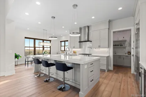 a kitchen with appliances a sink a counter top space and cabinets